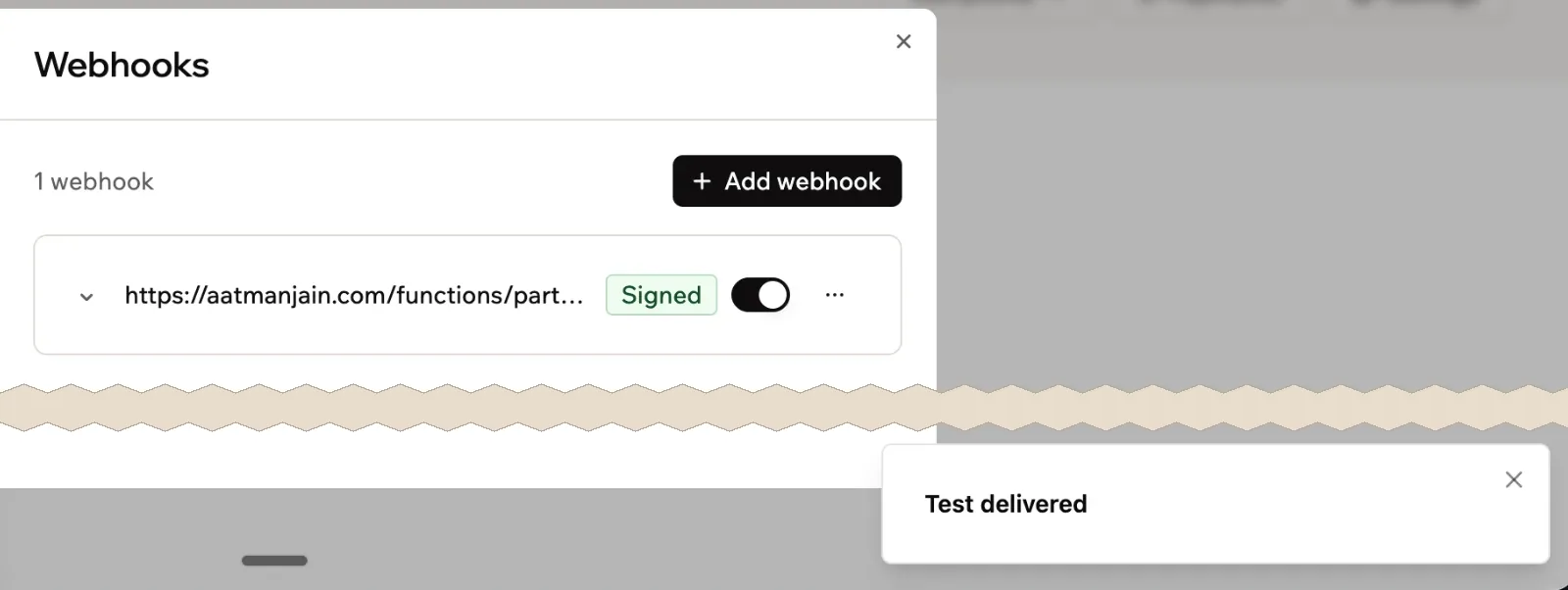 Base44's Webhooks settings: one webhook to aatmanjain.com/functions/partnerWebhook, Signed and switched on, and a Test delivered toast